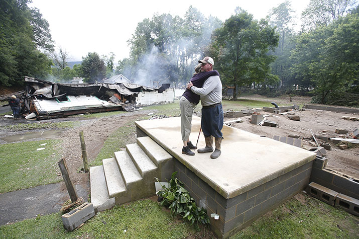 Two people hugging on porch