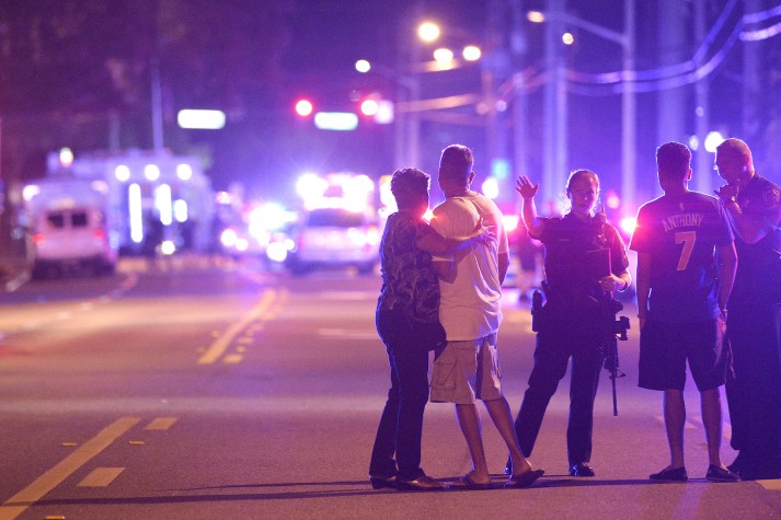 Orlando police officers direct family members away from a fatal shooting at Pulse Orlando nightclub in Orlando, Florida, on Sunday, June 12.
