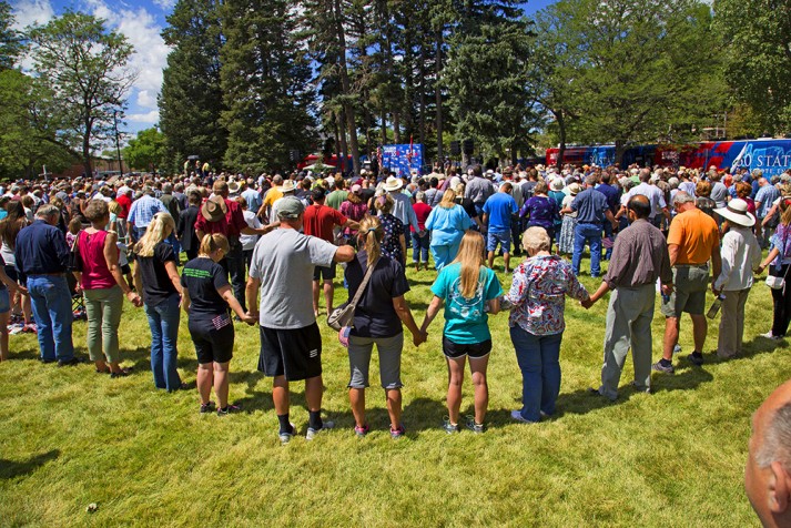 Young people praying hand in hand