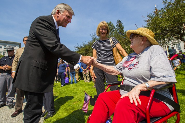 Woman sitting in chair, Franklin Graham shaking her hand