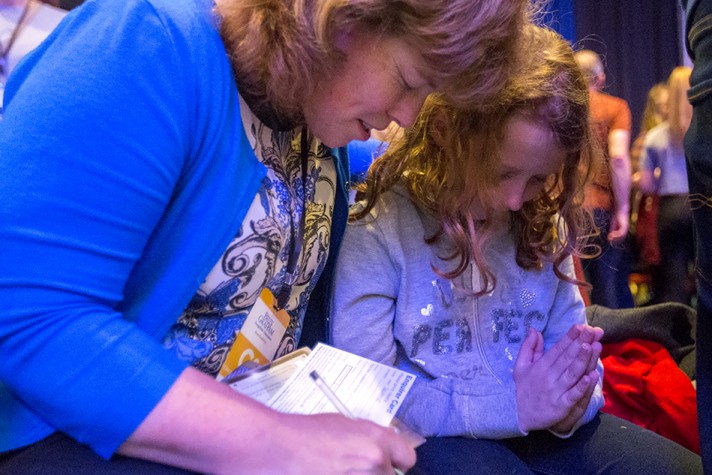 A counselor prays with Sophie