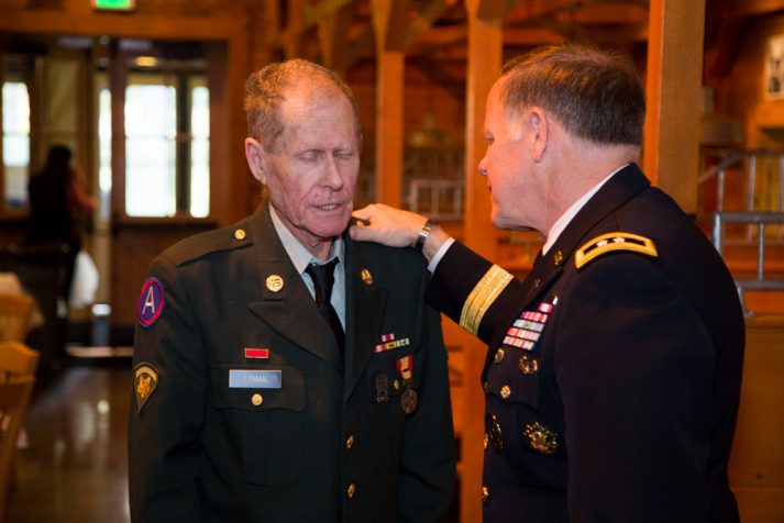 Retired Army Maj. Gen. Douglas Carver spends time in prayer with Albert Lyman, a retired solder who served in Vietnam.