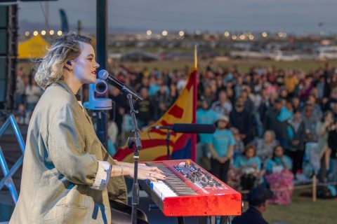 Taya leading worship at the God Loves You Tour in Yuma.