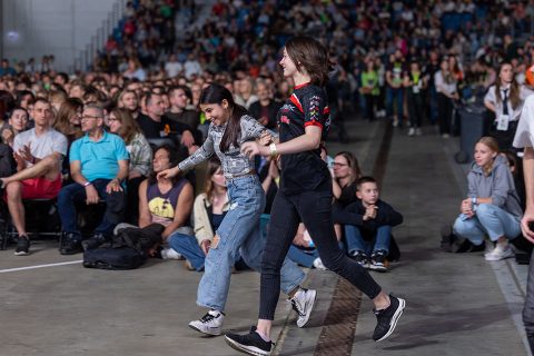 Two girls run to the stage at the invitation to make a decision for Jesus Christ at the God Loves You Tour stop at TAURON Arena Kraków.
