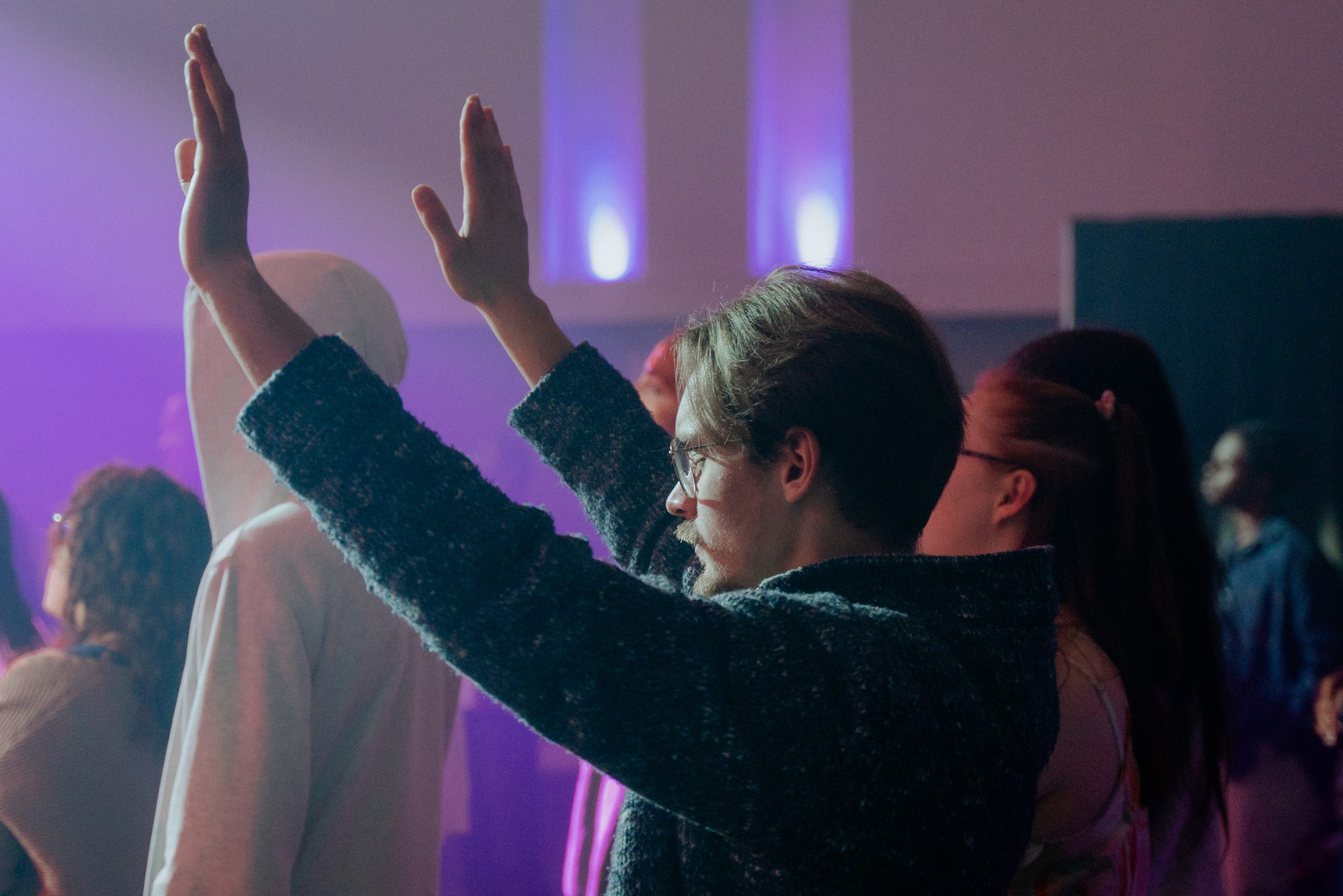 Man worshipping with arms raised.