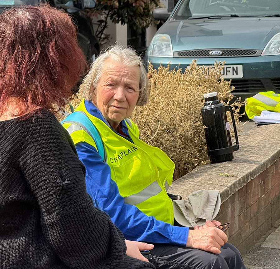 A Billy Graham Rapid Response Team chaplain ministers to a woman in Hainault.