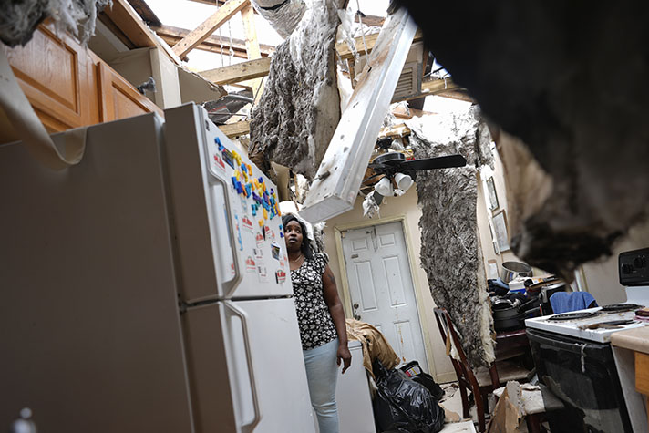 A Florida resident surveys her devastated home after Hurricane Milton made landfall on Wednesday night.