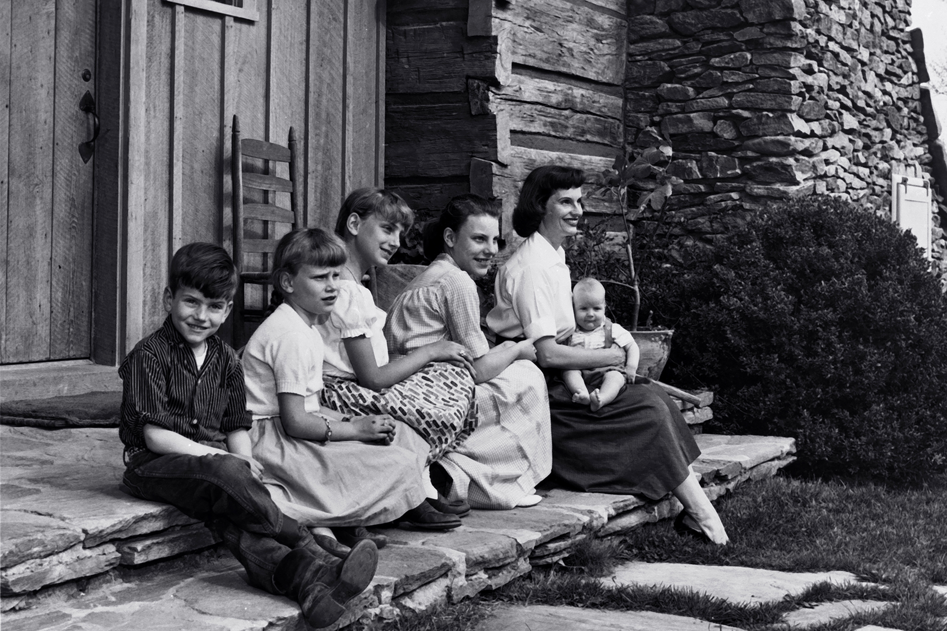 Ruth and her children Gigi, Anne, Ruth, Franklin and Ned sitting on the porch steps.
