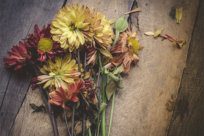 dying flowers on wooden box