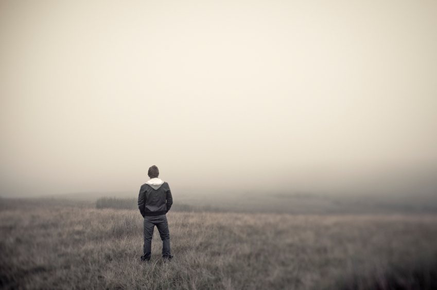 Man standing alone in field