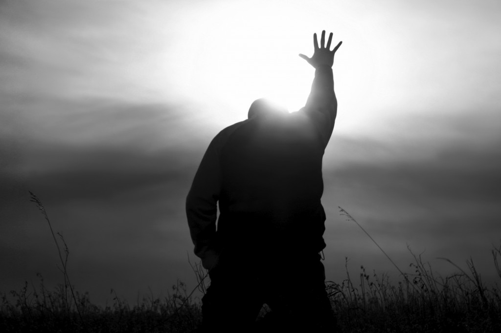 Man kneeling with arm outstretched