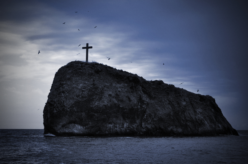 cross on top of rock