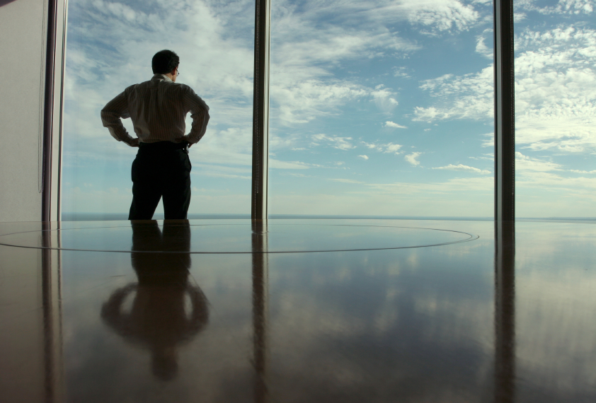 man looking out office window
