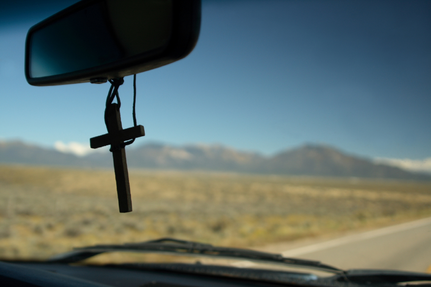 cross hanging in rear view mirror