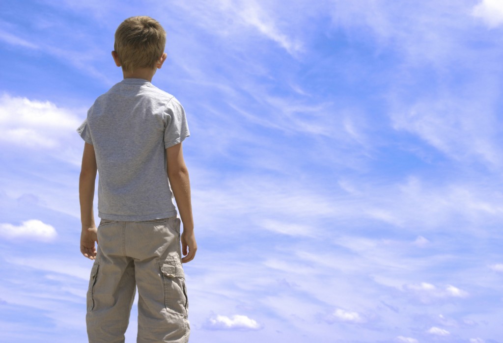 boy looking at blue sky