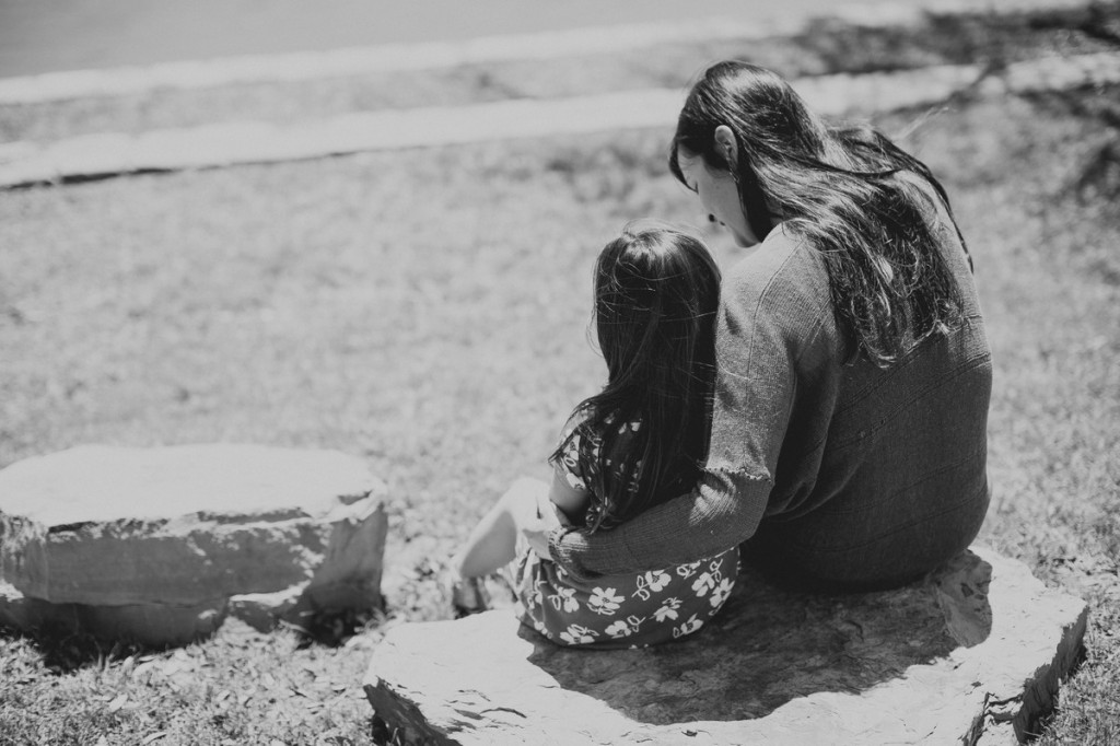 woman and girl sitting together