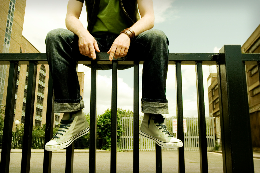 man sitting in fence