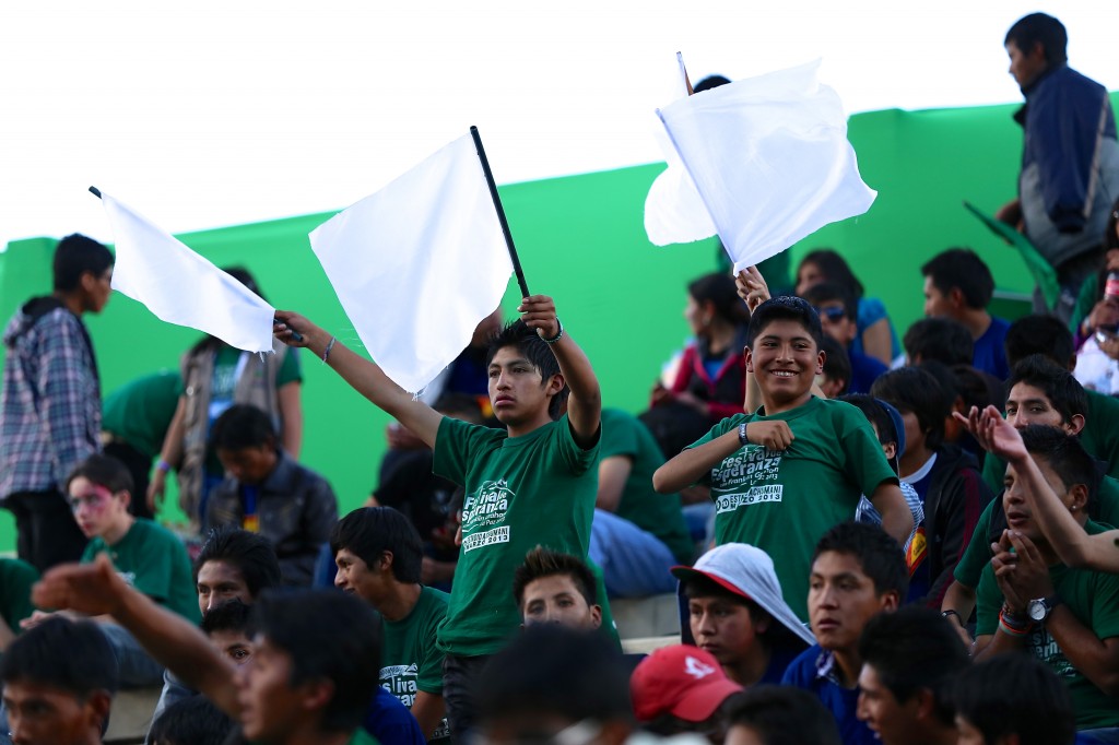 Youth in Bolivia wave flags
