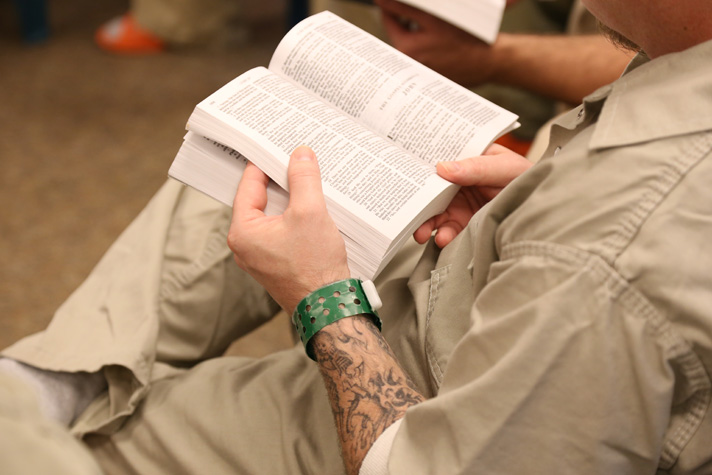 Prisoner with Bible open