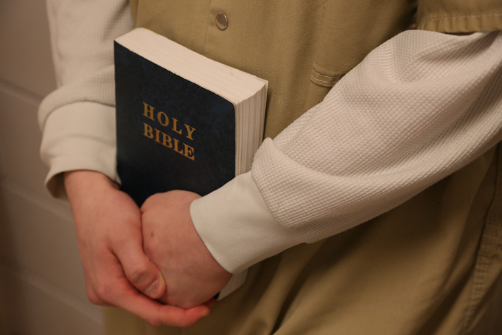 Inmate holding Bible