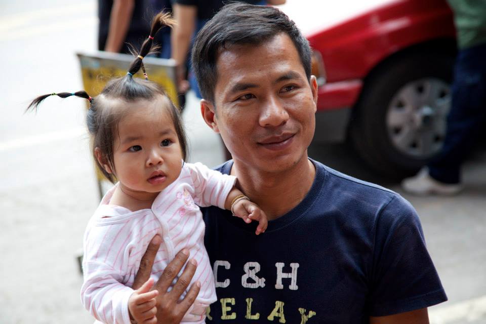 A man holds a little girl in Chiang Mai.