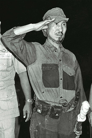 Hiroo Onoda salutes after surrendering on Lubang Island in the Philippine on March 11, 1974.