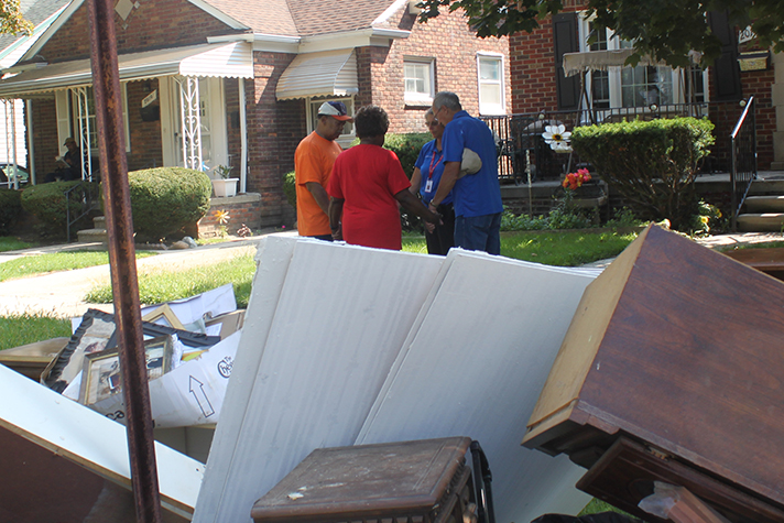 Chaplains with the Rapid Response Team pray with homeowners in Michigan on Monday.