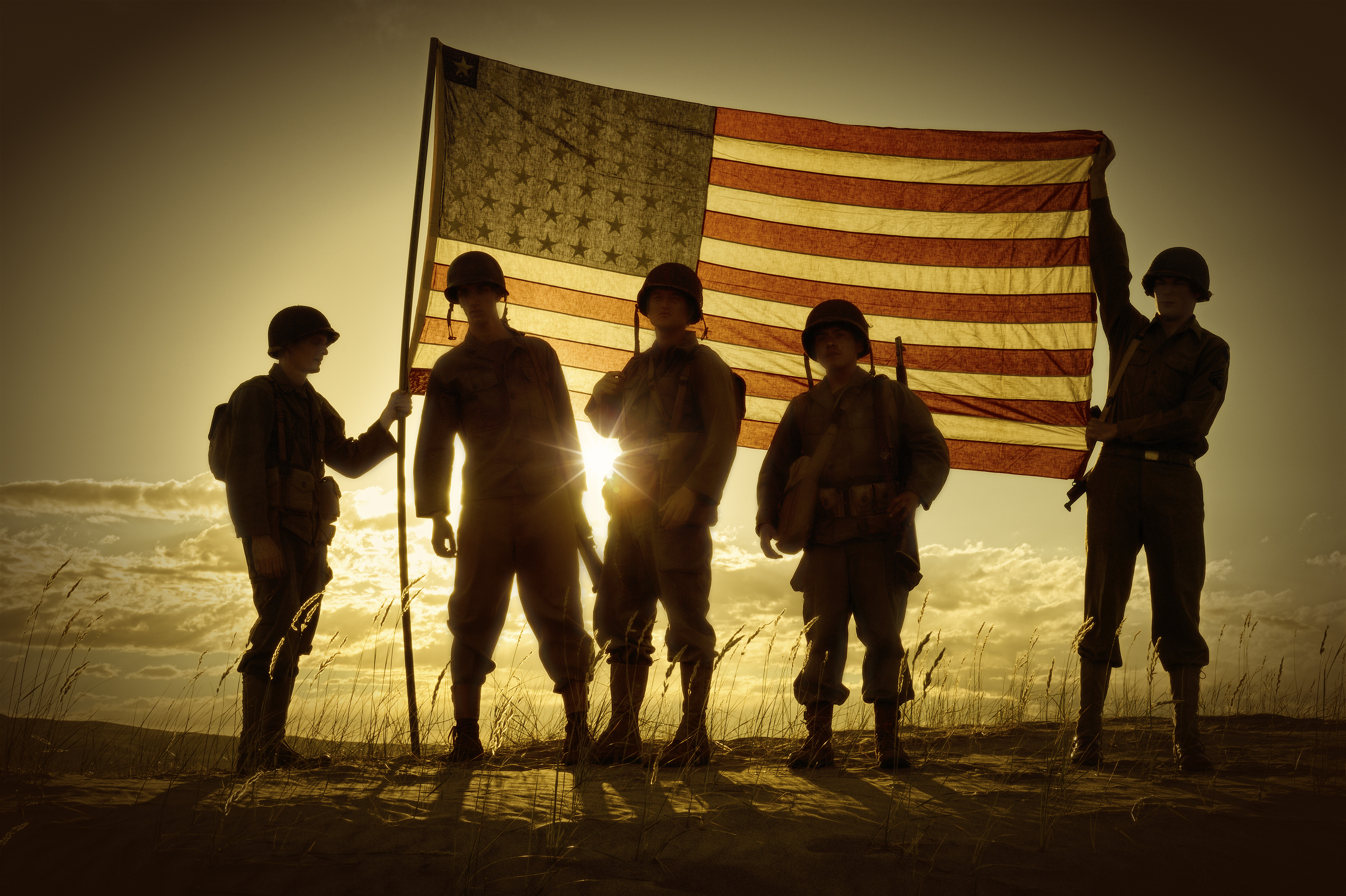 WWII Soldiers Standing In A Flag Draped Sunset – SIlhouette
