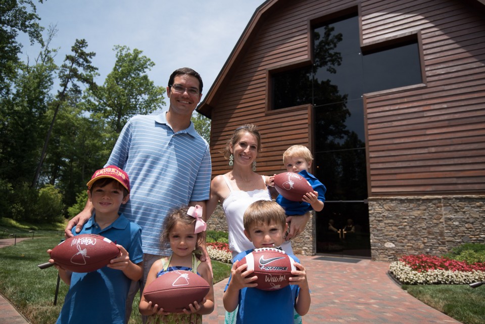 Family holding footballs