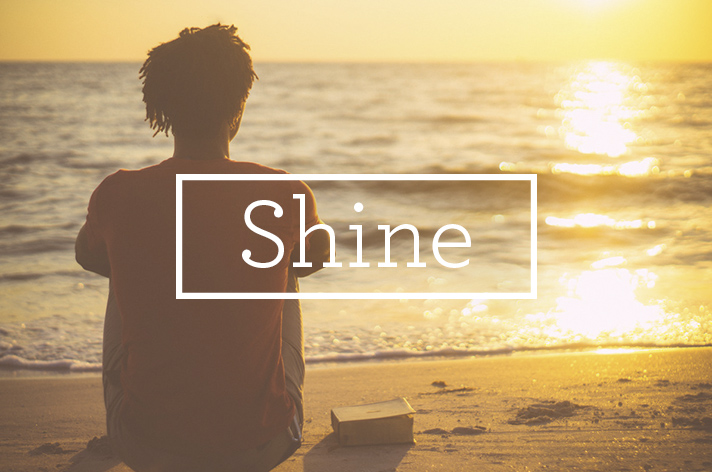 Man sitting on beach in sun