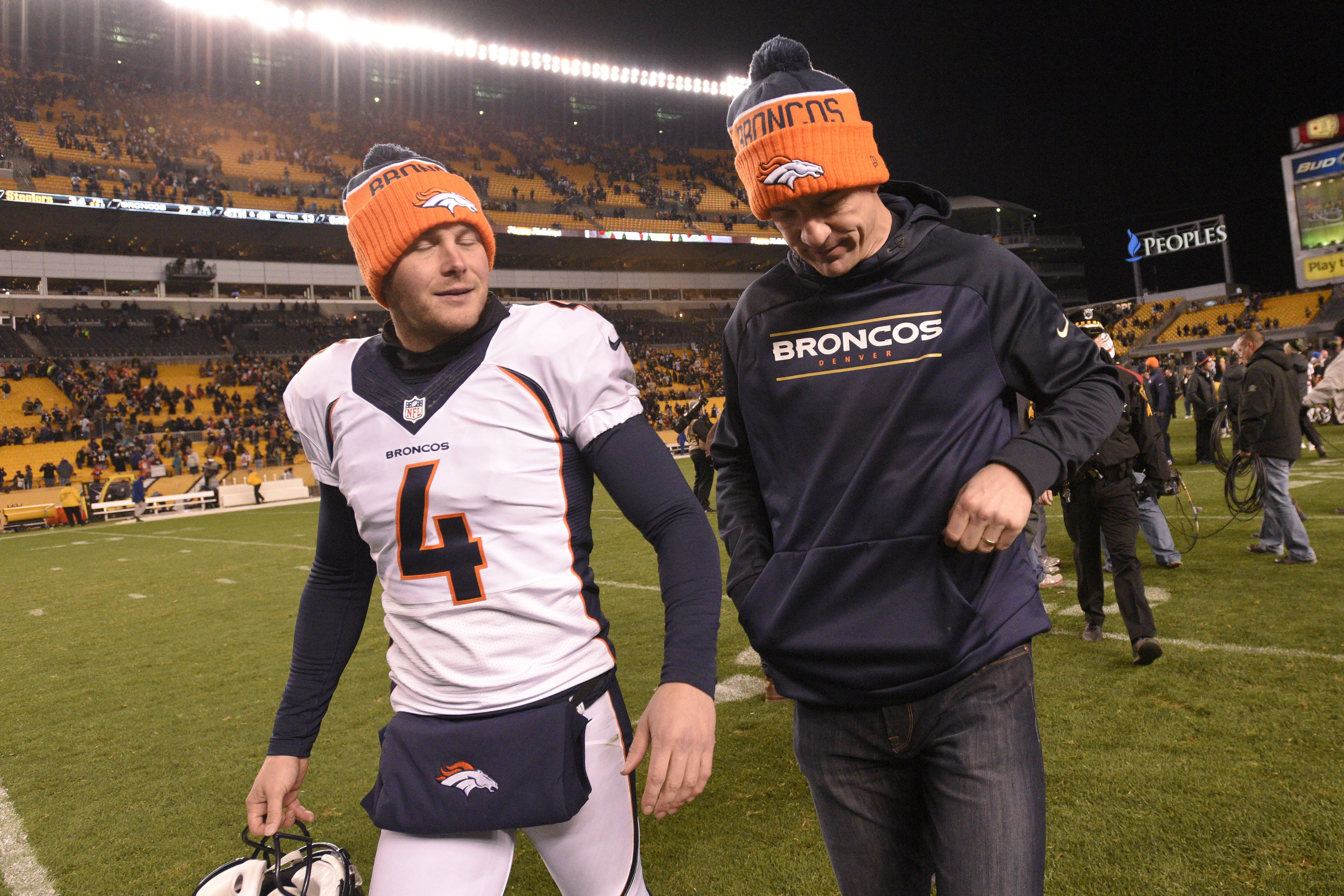 Denver Broncos punter Britton Colquitt (4) and quarterback Peyton Manning (18) leave the field after an NFL football game against the Pittsburgh Steelers, Sunday, Dec. 20, 2015, in Pittsburgh. The Steelers won 34-27. (AP Photo/Don Wright)