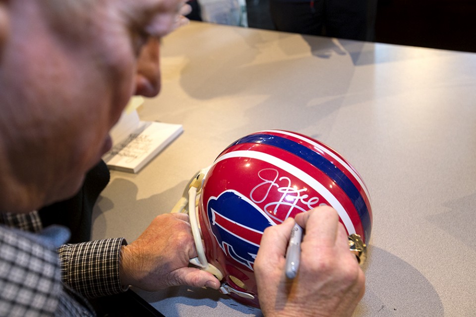 Jim Kelly signing helmet