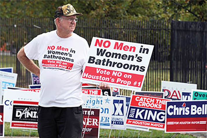 A man urges people to vote against the Houston Equal Rights Ordinance outside an early voting center in Houston on Wednesday, Oct. 21, 2015. The contested ordinance is a broad measure that would consolidate existing bans on discrimination tied to race, sex, religion and other categories in employment, housing and public accommodations, and extend such protections to gays, lesbians, bisexuals and transgender people. (AP Photo/Pat Sullivan)