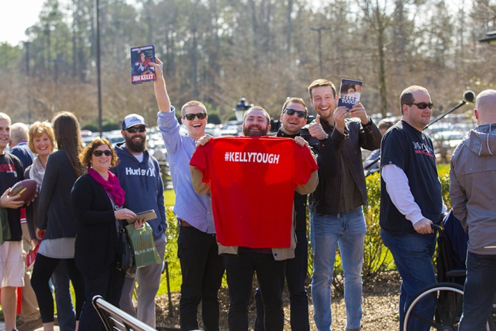 Fans holding T-shirt and books