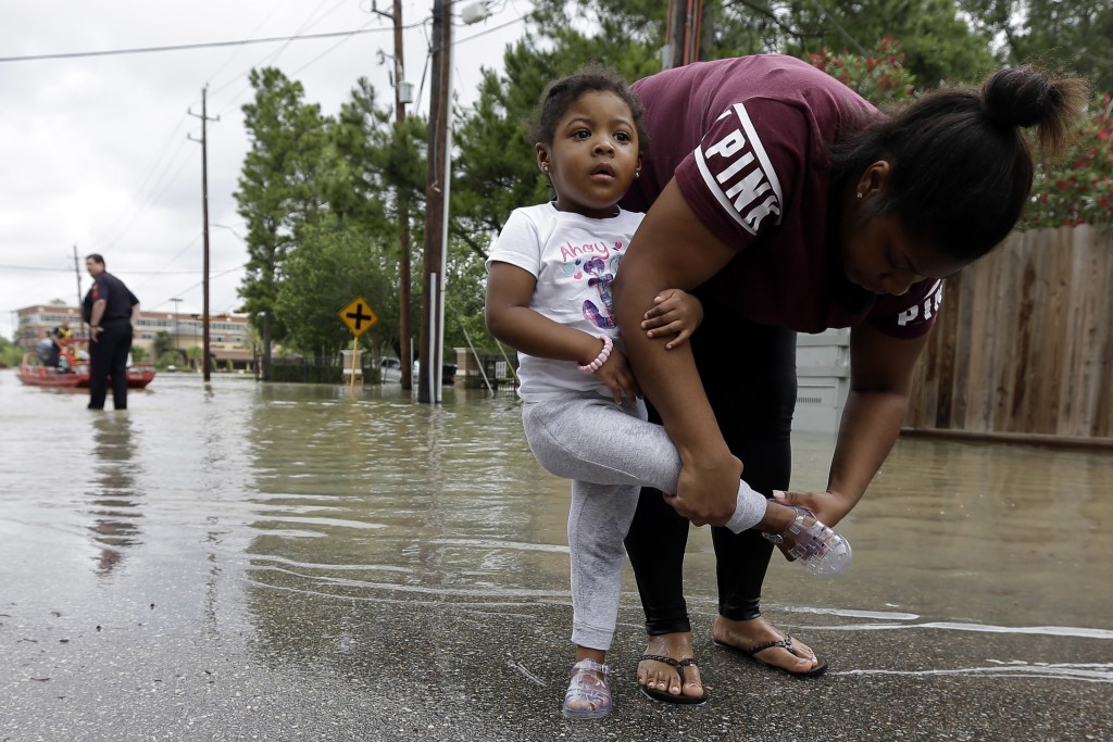 mother and daughter in flooded Houston street