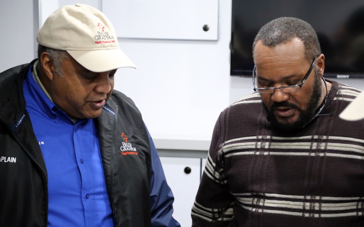 Pastor José Aguayo, left, a chaplain with the Billy Graham Rapid Response Team (RRT), has been deeply involved in working with the community of Ferguson, Missouri. Here, José prays with Michael Brown's uncle during the RRT deployment. Today, José oversees an effort geared toward bringing the church into the community. Jack Munday, RRT's international director, says José is "serving as a catalyst to bring the people together."