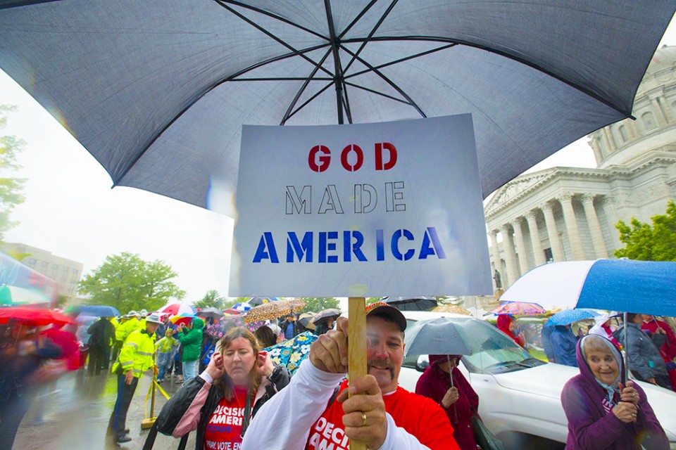 Man with 'God Made America' sign.
