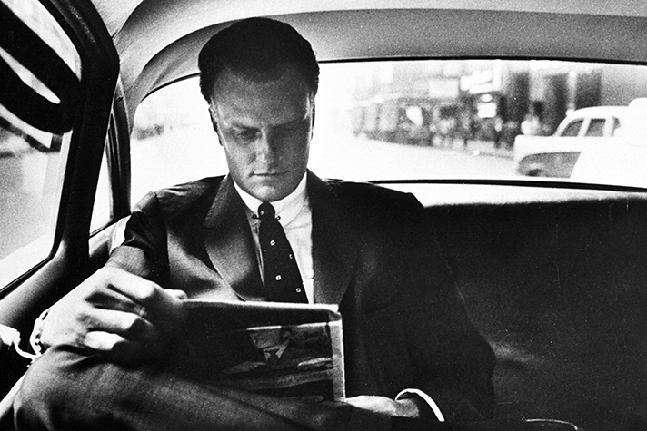 Billy Graham reading in car