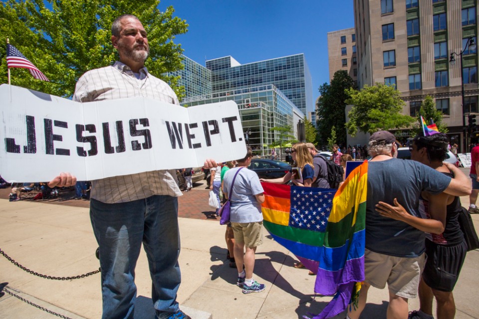 Man with 'Jesus Wept' sign