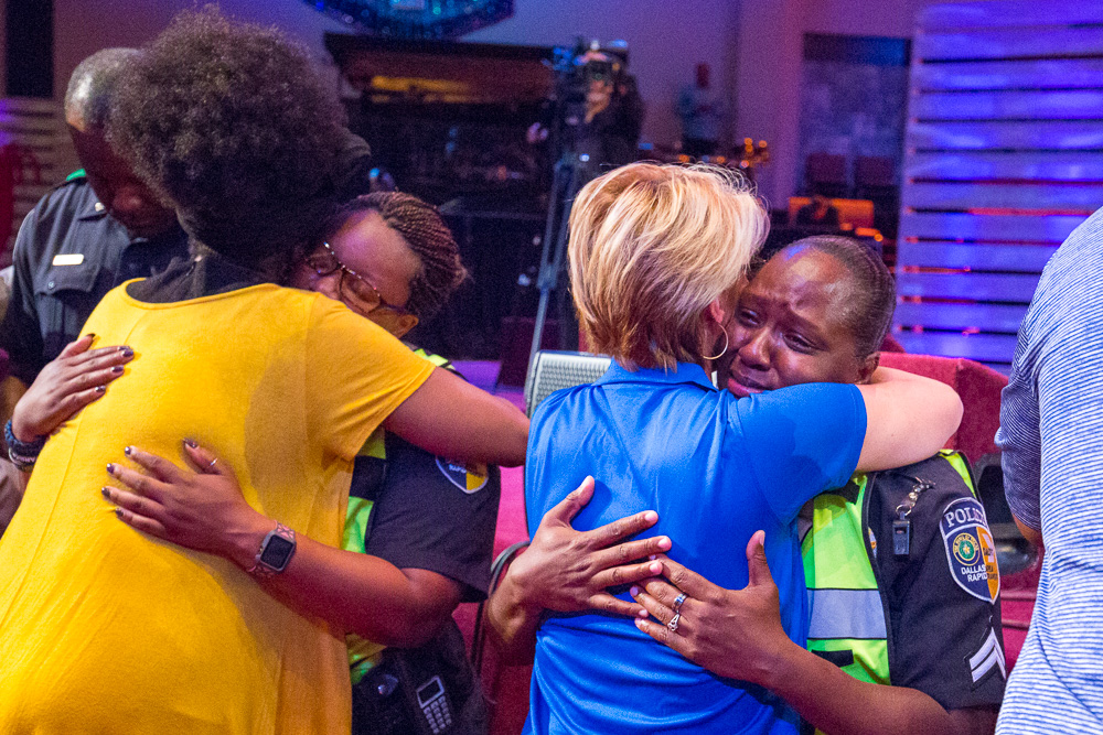 Women hug police officers