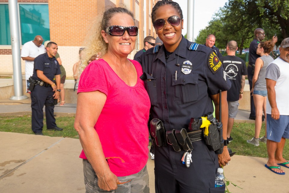 Woman poses with police officer