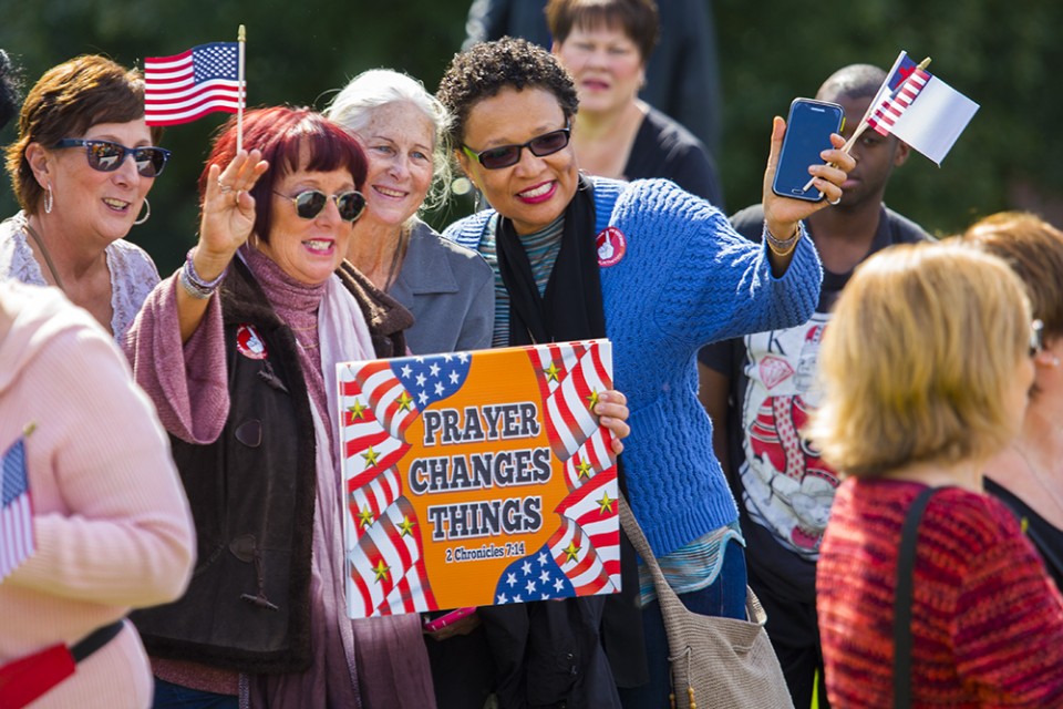 Women holding sign and flag