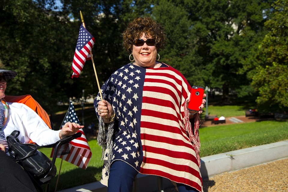 Woman wearing flag shirt and holding flag