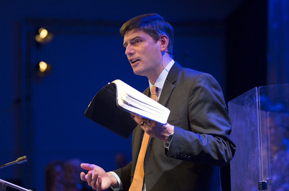 Will Graham preaching; holding open Bible
