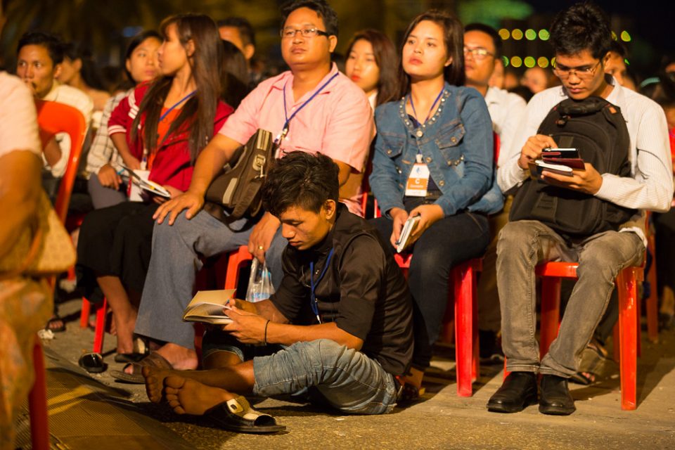 People sitting in chairs, on floor at Festival