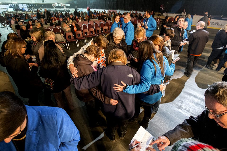 People huddled in prayer