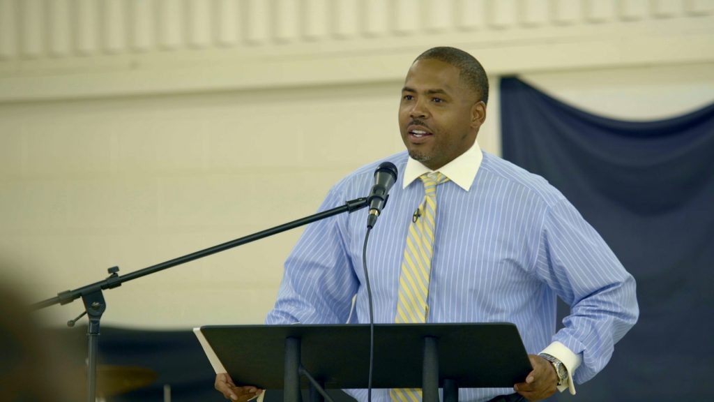 Man standing behind podium