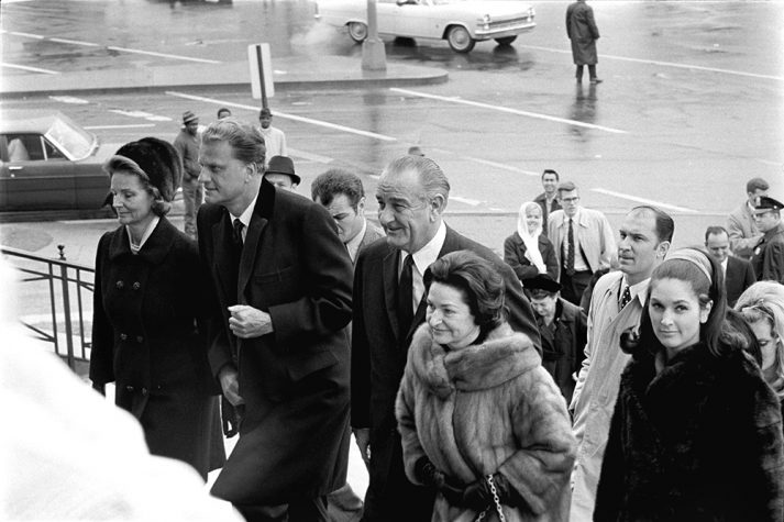 Billy Graham preached a sermon to President Lyndon B. Johnson and invited guests during a private event on Inauguration Day in 1965. Here, Billy Graham can be seen entering the Washington D.C. church with wife Ruth Bell Graham, President Johnson and his family.