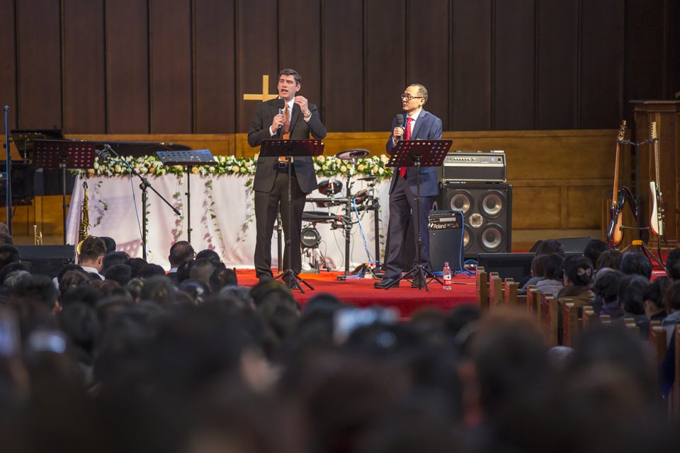 Will Graham preaching with interpreter standing beside him