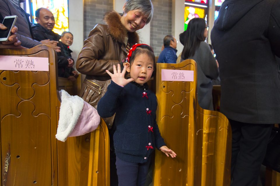 Little girl waves "Hi."